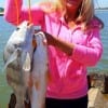 Visiting anglerette Eva Gamble from Celle Germany hoists these fine fish she caught on shrimp