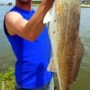 Chad Costello of Vidor TX hefts this 28inch slot red caught on soft plastic