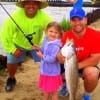 Proud Dad helps 4yr old Landry with her very first trout- a solid 5LBER- with teacher Gary Fruge looking on