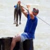 Keith Platt of Dayton TX hefting his hefty stringer of trout