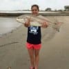 Maci Rowe from Tampa, Florida landed very her first red on light tackle, a  28inch slot red, landing it with help from the anglers around her.