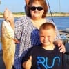 Mom Debbie Donahue with son Jessie teamed up to catch this nice 25inch slot red she caught on shrimp
