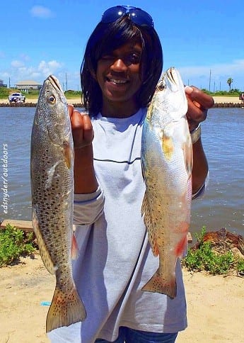 Michele Finley of Spring TX hefts these two nice specks caught on finger mullet and live shrimp