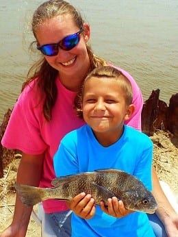 Mom and Son anglers Charlott Hindman and Alek of Crystal Beach TX show off 7 yr old Alek's yummy drum he caught on a Miss Nancy shrimp