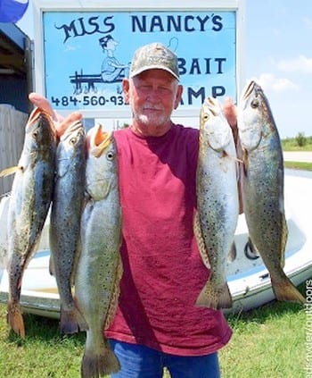 Tarkington Prairrie TX angler Frank Bunyard shows off part of his trout catch he took on finger mullet