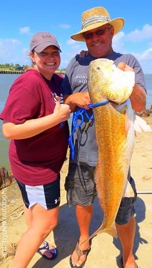 Father and daughter fishing team Wendell Stringfield and Lindsey Almeda of Poynor TX teamed up to land this HUGE 38inch tagger bull red on a Miss Nancy finger mullet