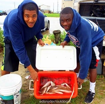 Houston Fishing buds Deandre and Jocquon are having fun loading up their cooler with croaker