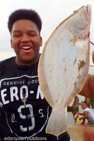 Jerrick Herring of Houston hefts this nice flounder caught on a Miss Nancy shrimp