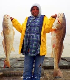 Austin angler Pedro Sanchez hoists these two tagger bull reds he caught on mullet