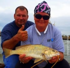 Fishing couple Shay and Brian Myers of Galveston show off Shay's HUGE 17 inch croaker she caught on shrimp
