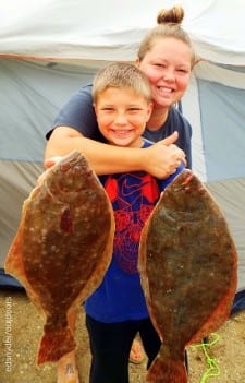Mom and Son anglers, Jessica Mathis gives a big thumbs up for Trent's fine limit of flounder he took on berkely gulp