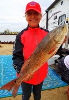 Nancy Wilkerson of Point Blank TX caught her very first redfish at Rollover, a 33inch tagger bull red she took on a finger mullet