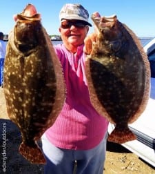 Rollover anglerette Poochie Walker holds up her flounder limit for today, 18 and 19 inchers she caught on gulp
