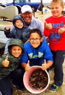 The Richards Family Group of Lufkin TX having fun on a rainy day at the Pass catching crabs