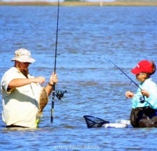 Wade angler action, wading couple catching flounder