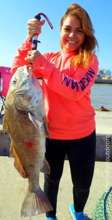 This HUGE drum that's almost big as she is, Houston anglerette Carolina Castro fished a Miss Nancy shrimp to catch and release this 34inch drum