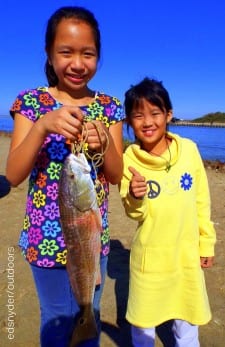 Young anglers Hillary Den and Ruby Chen of Pearland TX teamed up to show off this nice slot red caught on gulp