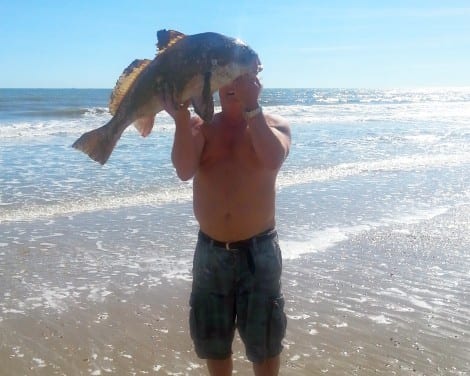 "I LOVE to surf fish," says Crystal Beach angler Rickey Rivers, showing the BIG BLACK DRUM he caught last week in the surf.