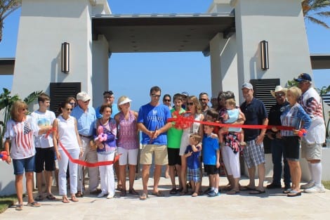 Joined by family, friends, and many guests, Brad Ballard cuts the ribbon to announce the Grand Opening of Seagrass Beach