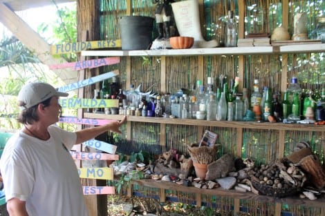 Margaret's house is a museum of  beachcombing items. Here she is showing the collection of bottles found washed up on the beach.