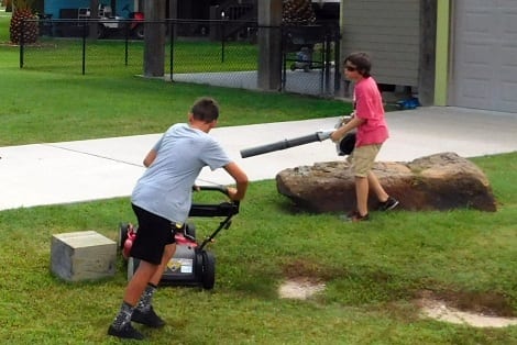 Lance handles the push mower, while Carson mans the blower.