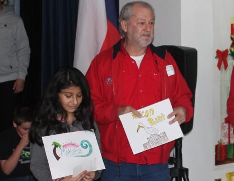 Tim Byrom with Stephany Doroteo, showing the winning entries.