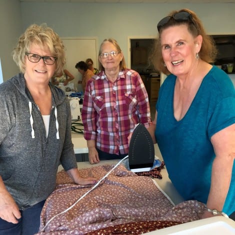 Becky Stafford, Janet Smith and Margaret Fowler "iron out" plans for a dress.