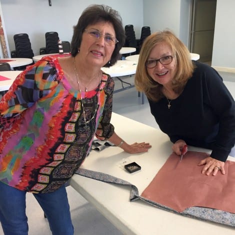 President Mary Raney and Esther Sarabia confab over the best way to create their design.